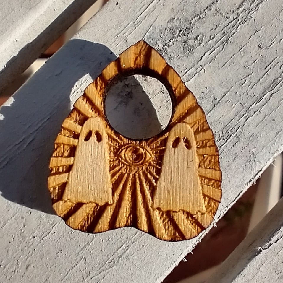 A detailed view of the planchette piece that goes with the Haunted Spirit Board MINI