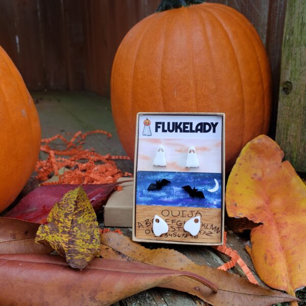 A photo of Flukelady's Ghostie Posties Earring Set in a fall setting.