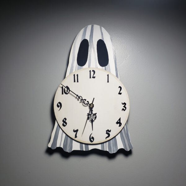 A ghost-shaped analog clock featuring a hand-painted ghost design based on Flukelady's popular sheet ghosts.